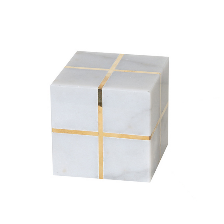 A cube of contrast - cool marble, warm brass